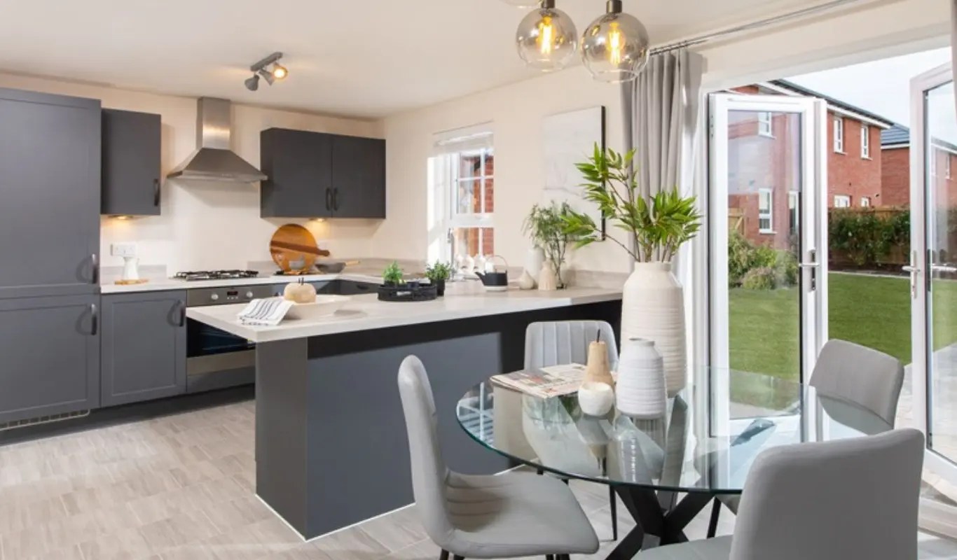 Kitchen-diner with doors opening onto the garden in a Barratt Home at Wintringham