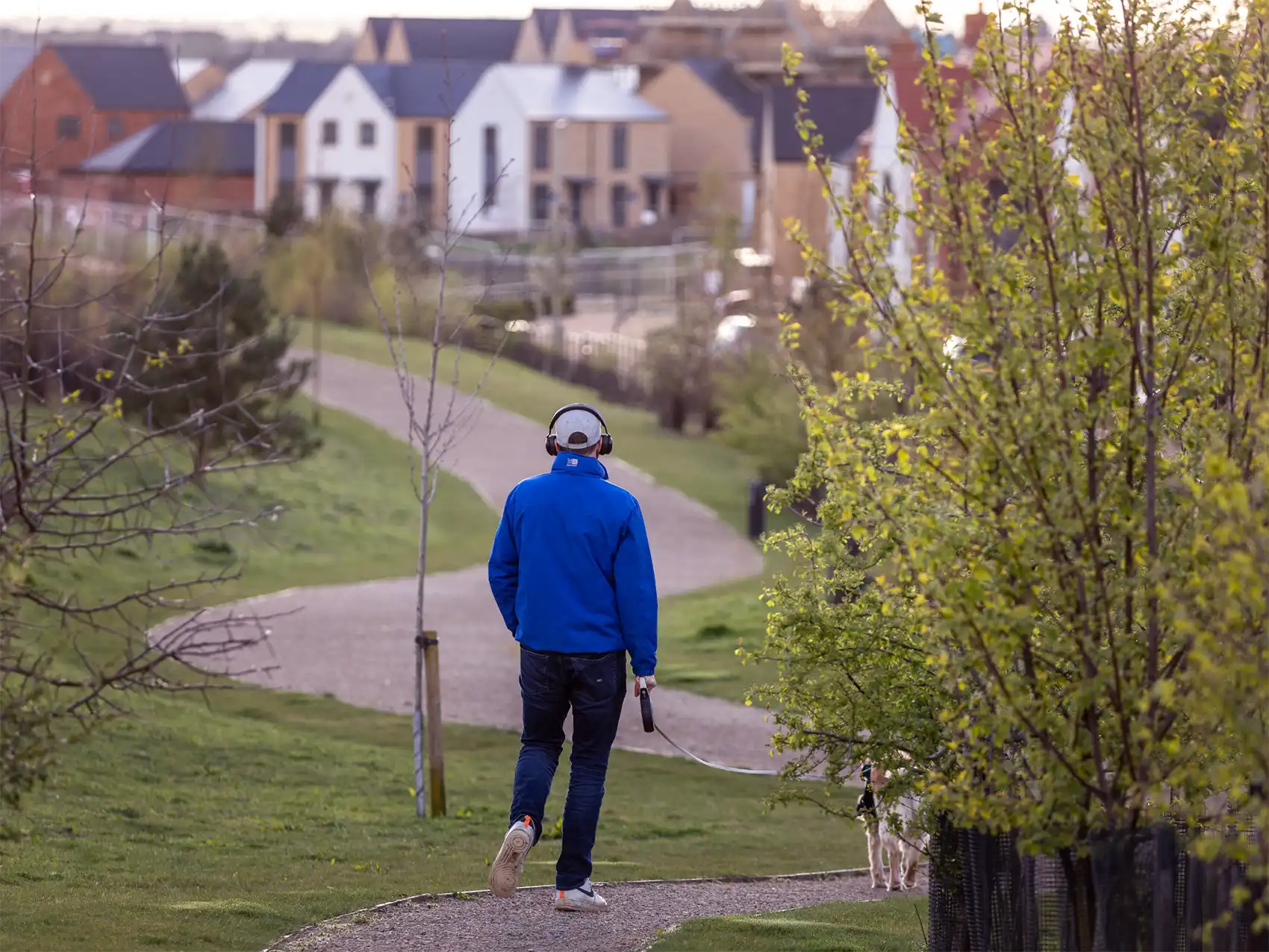 A man walking his dog through the park