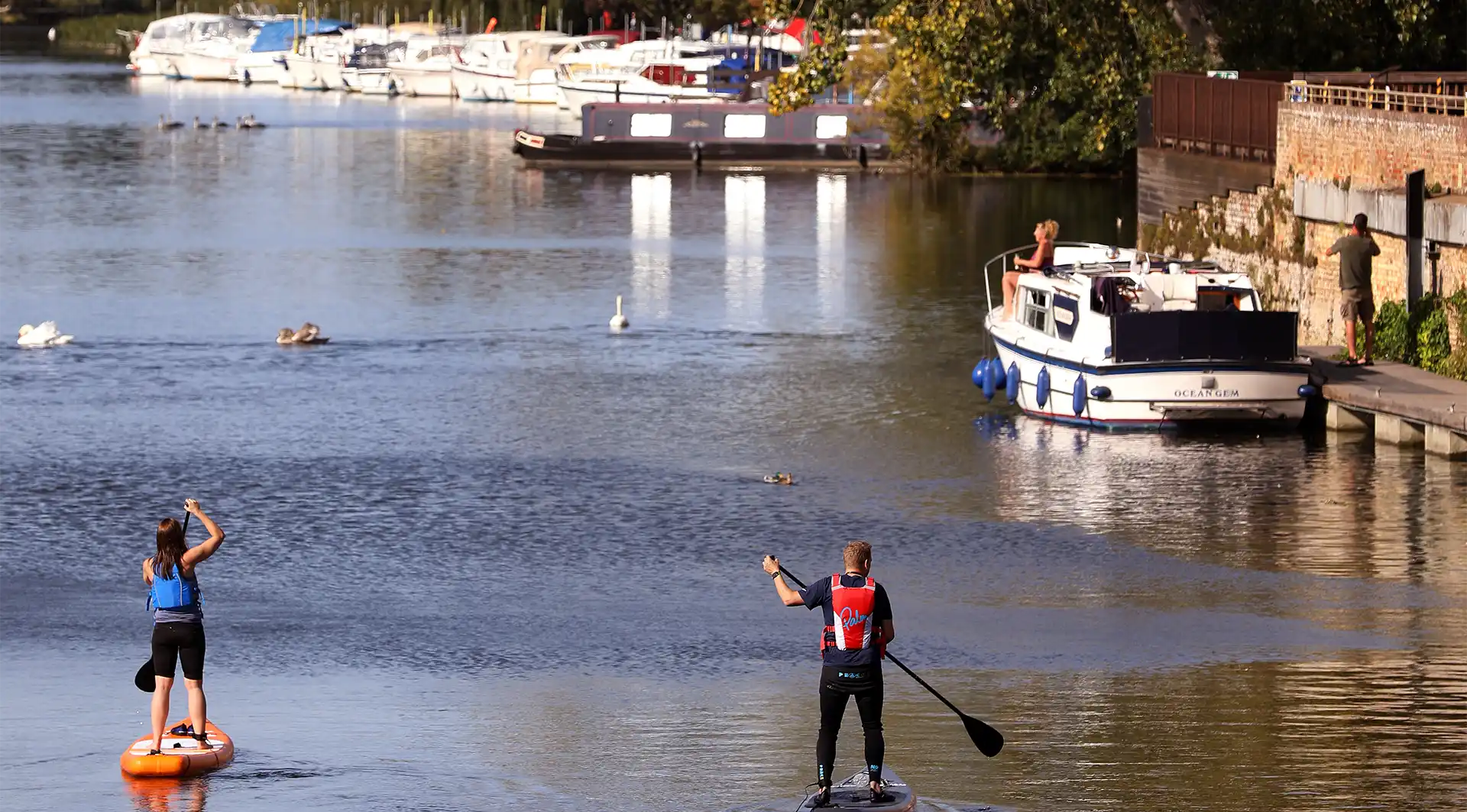 People standup paddle boarding at Wintringham